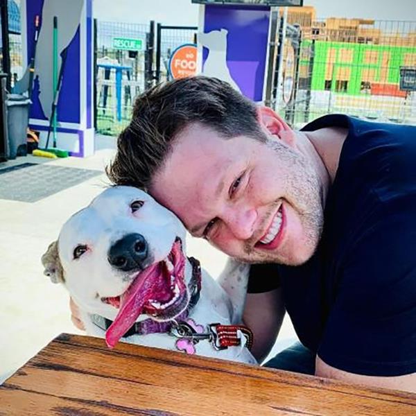 HIV scientist Jordan Willis is pictured with his dog.