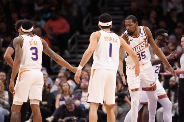 Kevin Durant #35 of the Phoenix Suns high fives Bradley Beal #3 and Devin Booker #1