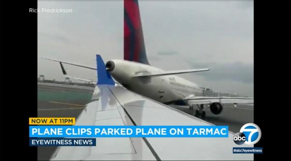 pictured is the wing of a United Airlines plane clipping the tail of a parked Delta flight. 