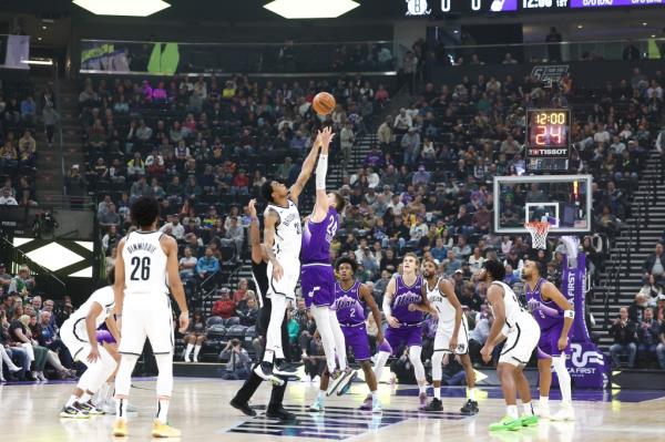 Brooklyn Nets center Nic Claxton (33) and Utah Jazz center Walker Kessler (24) tip the ball off to start the game at Delta Center.