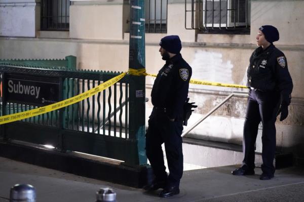 Police officers at a taped-off crime scene outside a Bronx subway station wher<em></em>e a 15-year-old was critically injured in a shooting incident