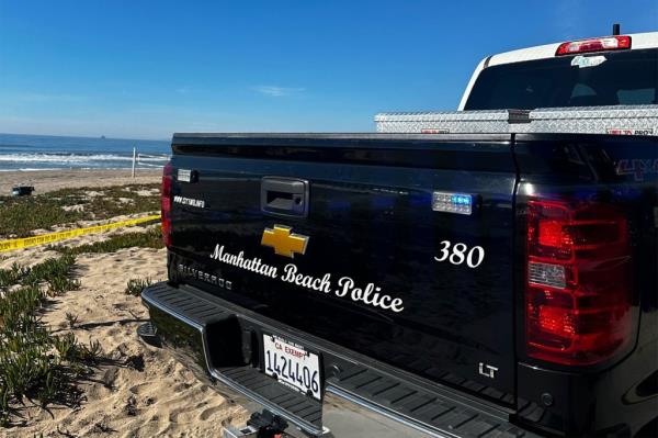 A police truck on the beach.