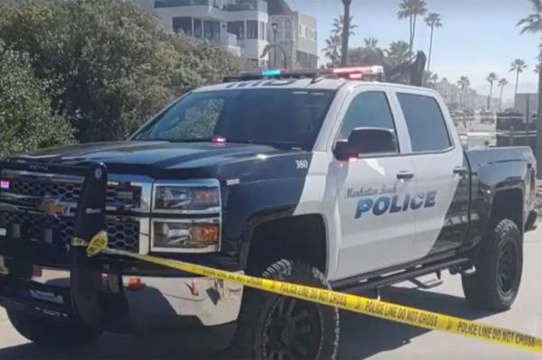 A police truck on the beach.