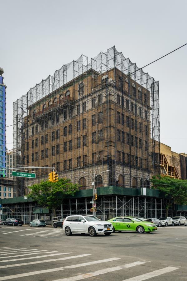 1301 Stillwell Avenue wrapped in scaffolding