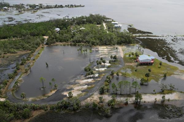 In this photo made in a flight provided by mediccorps.org, an evacuated flooded RV park is seen near Keaton Beach, Florida