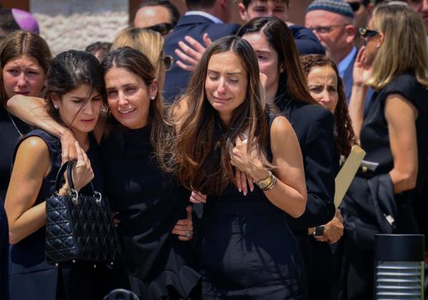 Mourners support one another as they exit Temple Beth Sholom after the funeral service for 15-year-old Ella Adler, Monday, May 13, 2024.