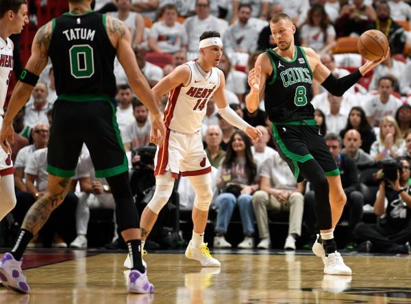 Celtics center Kristaps Porzingis (8) turns on Miami Heat guard Tyler Herro (14) during the first quarter of Game 4.