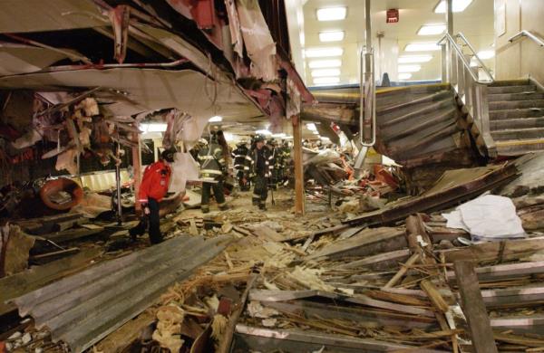 Emergency workers walk through the destroyed interior of the Staten Island Ferry boat Andrew J. Barberi.