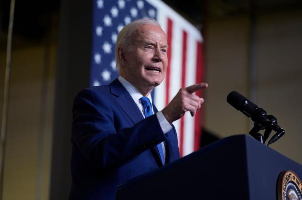 President Joe Biden delivering remarks on his 'Investing in America agenda' at Gateway Technical College, pointing at a microphone