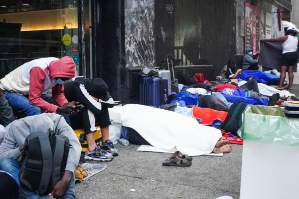 Migrants sleeping on the sidewalk outside of the Roosevelt Hotel on August 3, 2023 as they wait to be admitted.