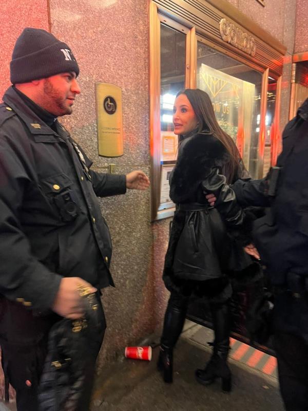 Lisa Ann talking to a security guard. 