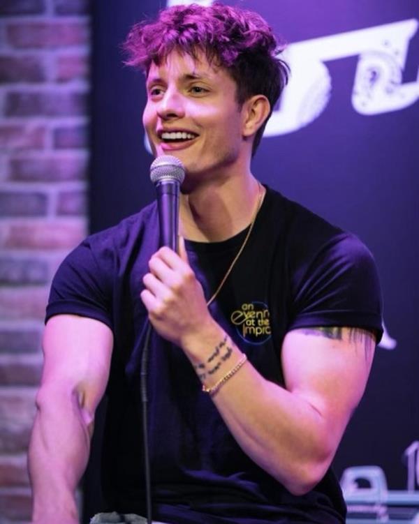 Matt Rife smiling onstage. 