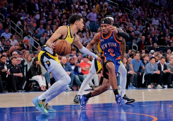 Pacers guard Tyrese Haliburton #0 drives down court as New York Knicks guard Miles McBride #2 gives chase