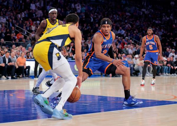 Pacers guard Tyrese Haliburton #0 drives down court as New York Knicks guard Miles McBride #2 gives chase