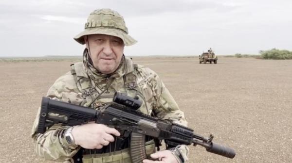 Wagner chief Yevgeny Prigozhin holding a gun.