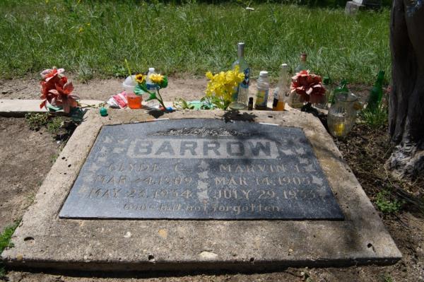 Barrow. Clude C. Mar 24, 1909. May 23, 1934. Marvin I. Mar 14, 1905. July 29, 1933. Gone but not forgotten. The ins<em></em>cription is on a grave with some flowers, and two half-finished drinks bottles, one of Corona beer. 