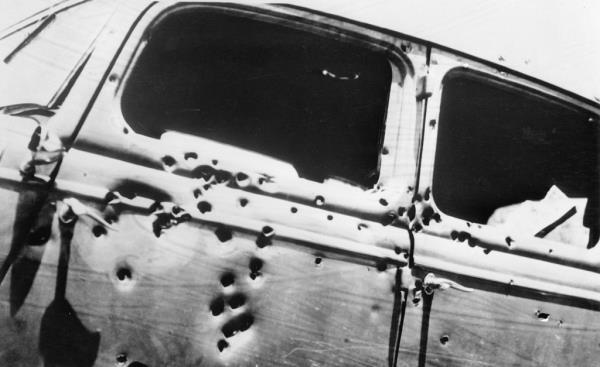 The side of a 1930s Ford V8 sedan riddled with bullets. Bo<em></em>nnie and Clyde were inside.