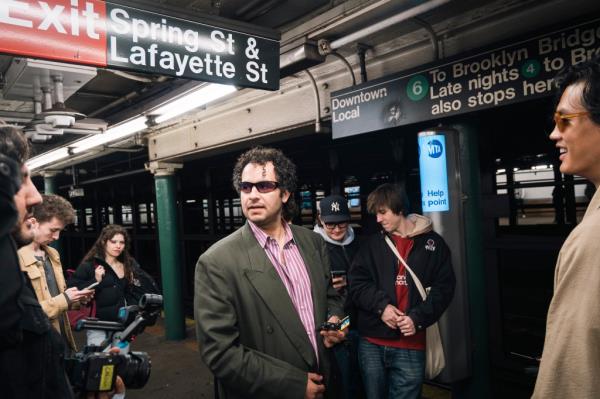 Kareem Rahma at the Spring Street station, various people in the background. 