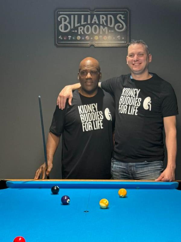 The pair playing pool together. 