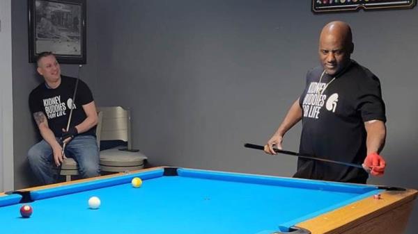 The pair playing pool together. 