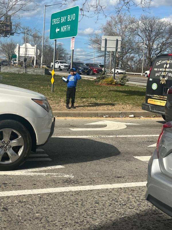 A young migrant boy selling candy near the Cross Bay Boulevard entrance to the Belt Parkway in Howard Beach. 