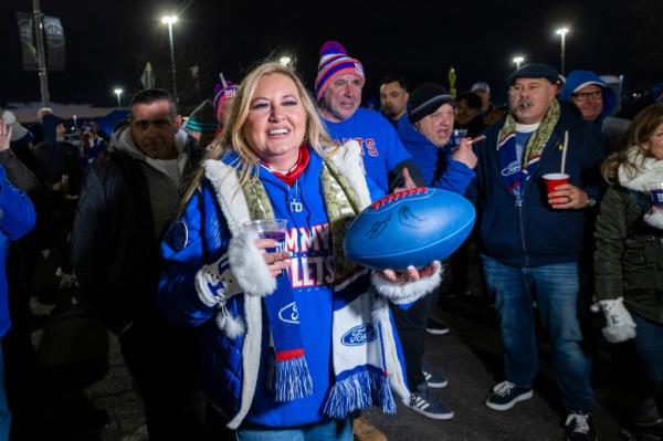 Lexy Devito, mother of New York Giants Tommy DeVito, holds a football at a tailgate before a game against the Green Bay Packers at MetLife Stadium, Monday, Dec. 11, 2023, in East Rutherford, NJ.