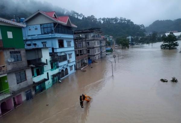 Flood waters inundate buildings along the Teesta river in Sikkim, India, Wednesday, Oct. 4, 2023. Twenty-three Indian army soldiers are missing after a cloudburst triggered flash floods in the northeastern state of Sikkim. The flooding occurred along the Teesta River in Lachen valley, a statement from India's army said Wednesday, adding that search efforts were underway. (Indian Army via AP)