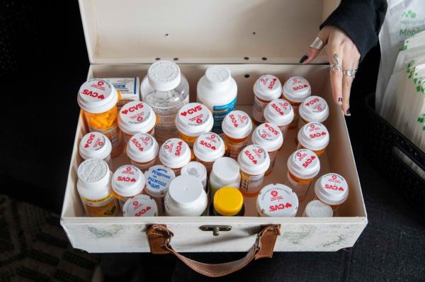 Amber Escudero-Kontostathis' shows the medication she was on at her home in Washington, D.C., on March 10, 2023. 