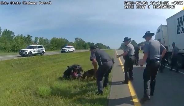 This image taken from police body cam video shows a police dog attacking Jadarrius Rose, 23, of Memphis, Tenn., on Tuesday, July 4, 2023, in Circleville, Ohio