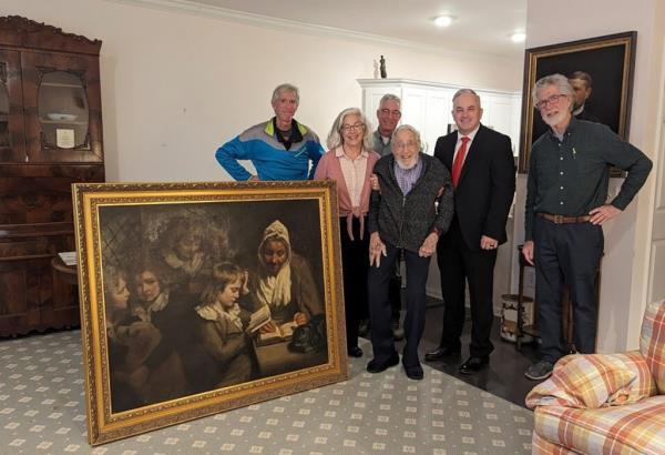 Special Agent Gary France, second right,, Dr. Francis Wood and Woods children stand next to the John Opie painting that was stolen from Woods parents' home in 1969 in Newark, N.J.