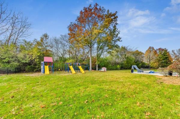 The children's swing set remains in the backyard.