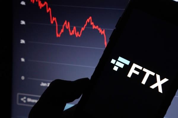 FTX website and FTX logo displayed on a computer screen in New York, NY on November 19, 2022