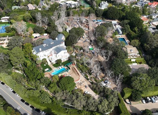 There's also a larger pool on the property located behind trees.