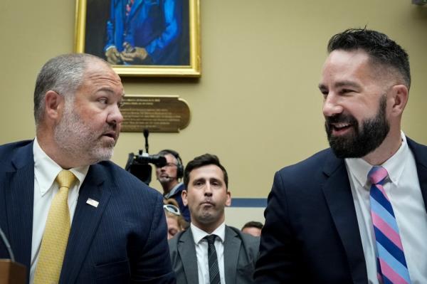 Supervisory IRS Special Agent Gary Shapley and IRS Criminal Investigator Joseph Ziegler talk with each other as they arrive for a House Oversight Committee hearing related to the Justice Department's investigation of Hunter Biden, on Capitol Hill July 19, 2023 in Washington, DC. 