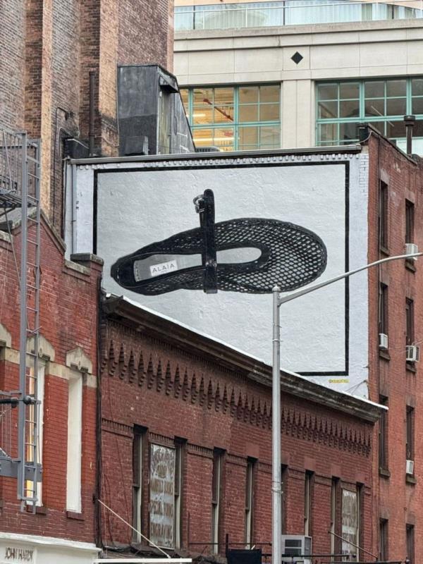 A billboard in Manhattan's SoHo displaying a giant painting of Ala?a's ico<em></em>nic crystal-studded, rubber-soled Mary Jane shoe