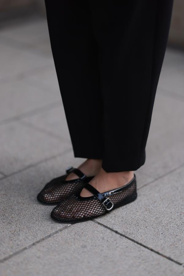 Aylin Koenig wearing Zara black fabric long pants and Alaia black mesh ballerinas in Hamburg, Germany, March 2024