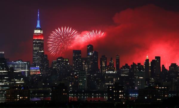 Macy's 4th of July fireworks illuminating the sky next to the Empire State Building in New York City on July 4, 2023.