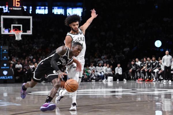  Nets guard Dennis Schroder (17) brings the ball up court while being defended by Milwaukee Bucks guard Andre Jackson Jr. (44) during the first half at Barclays Center. 