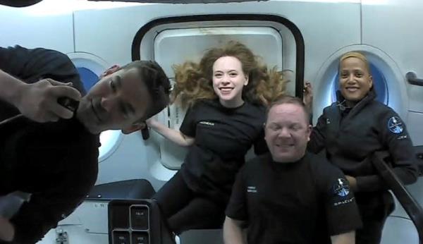 Isaacman, left, radios in from space as head of the first private flight to the stars in 2021.