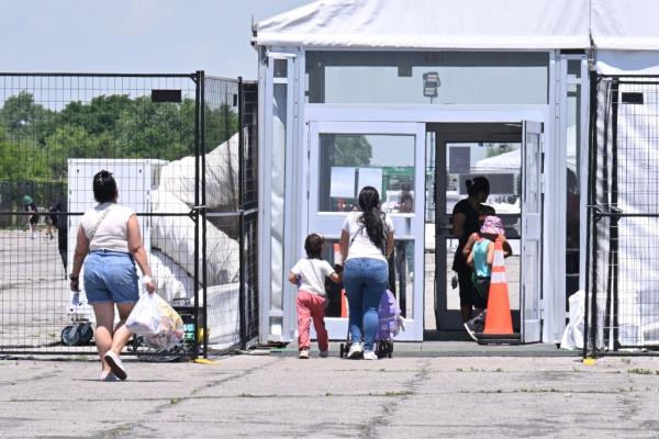 People entering Floyd Bennett Field Migrant Center on June 7, 2024