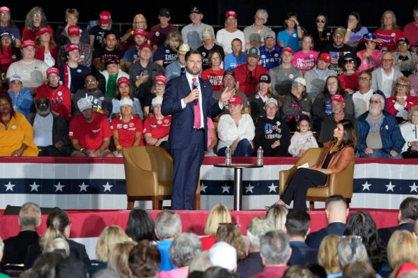 Republican vice president nominee Sen. JD Vance speaking at a campaign event while moderator Danica Patrick looks on, encouraging the crowd to bring a friend to the polls to vote.