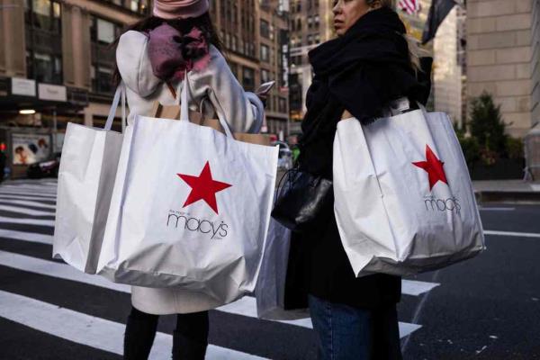 Shoppers carry Macy's bags during Black Friday in New York