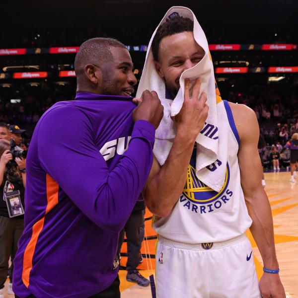 Stephen Curry #30 of the Golden State Warriors and Chris Paul #3 of the Phoenix Suns smile after the game on October 25, 2022 at Footprint Center in Phoenix, Arizona.