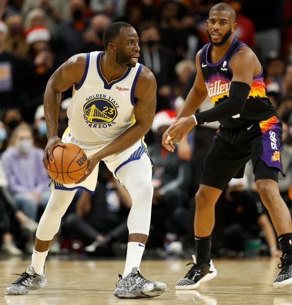 Draymond Green #23 of the Golden State Warriors handles the ball against Chris Paul