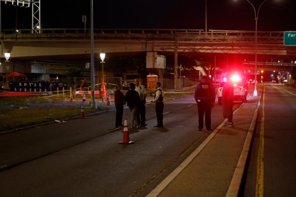 Police respond to the scene wher<em></em>e three men were shot at  Beach 95th Street near Beach Channel Drive in Rockaway Beach.