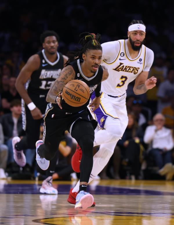 Ja Morant #12 of the Memphis Grizzlies dribbles ahead of Anthony Davis #3 of the Los Angeles Lakers Game 3 of the Western Co<em></em>nference First Round Playoffs at Crypto.com Arena on April 22, 2023 in Los Angeles, California. 