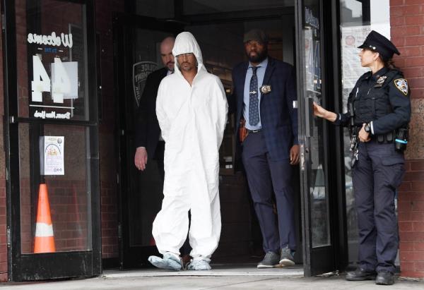 Sheldon Johnson getting walked out of the 44th Precinct statio<em></em>nhouse in the Bronx.