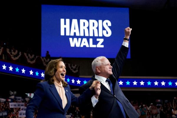 U.S. Vice President Kamala Harris and Minnesota Governor Tim Walz raising their hands at a campaign rally in Philadelphia after announcing their 2024 Presidential run