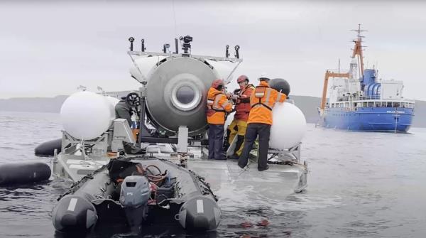 A group of people on a boat during Ocean Gate Expeditions, Titan Mission III, featuring Jake, also known as Dallmyd on YouTube, and Fuzati.