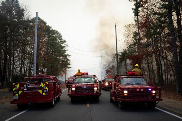 Firefighters and fire trucks respo<em></em>nding to a forest fire in Evesham, New Jersey on November 6, 2024